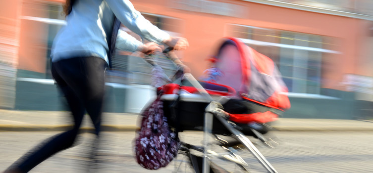 Mother walks with the child in the stroller